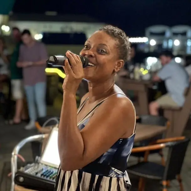 A singer performing at night on the deck